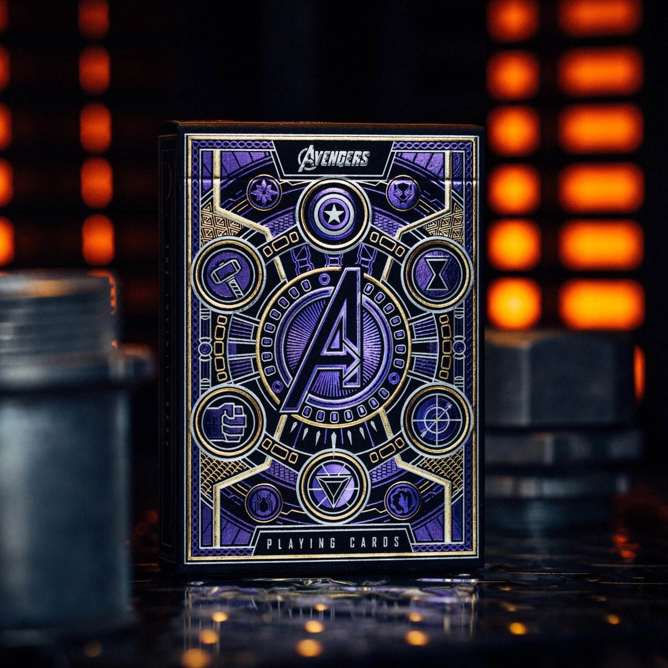A pack of premium playing cards with Avengers: Infinity Saga theme, featuring purple and gold colors with character icons on the packaging.